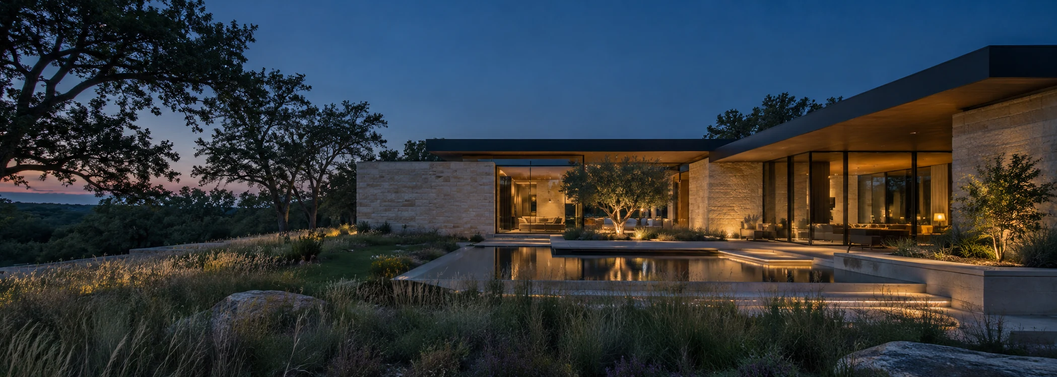 Fictional contemporary limestone residence surrounding a planted courtyard and reflecting pool at blue hour